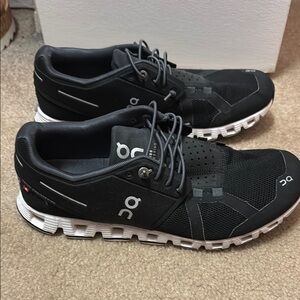 On Running Black and White Athletic Shoes with Cloud Cushioning